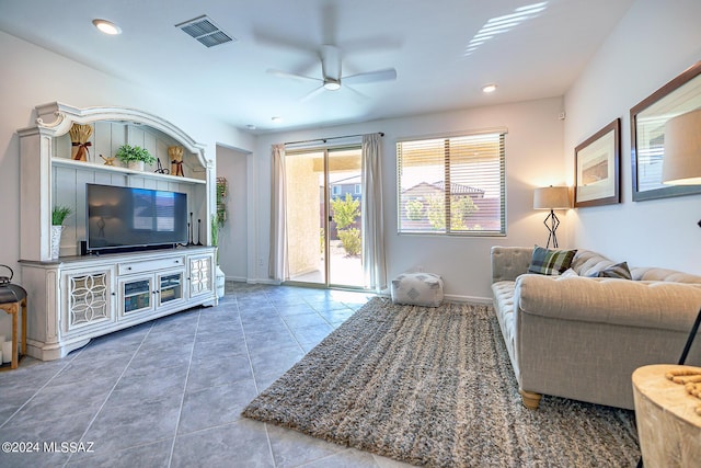 tiled living room with ceiling fan