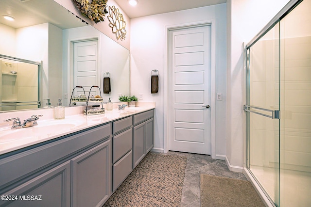 bathroom with a shower with door and vanity