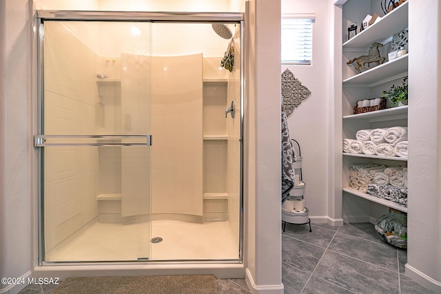 bathroom featuring a shower with shower door