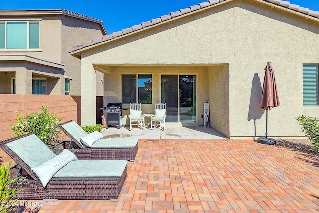 back of property with a patio