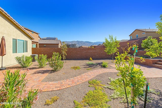 view of patio featuring a mountain view and central AC unit