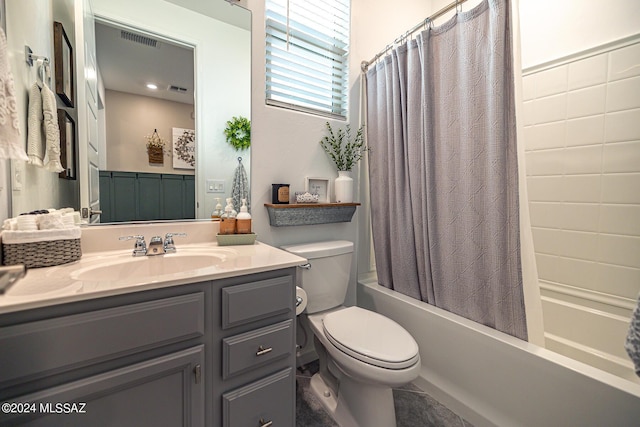 full bathroom with shower / bath combo with shower curtain, vanity, and toilet