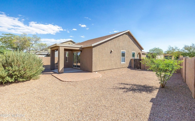 back of house with a patio