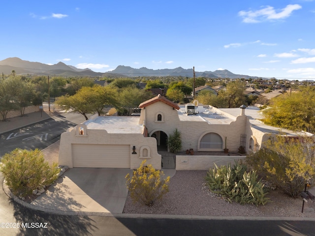 view of front of house with a mountain view and a garage