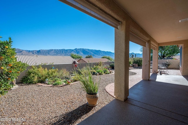 view of patio / terrace with a fenced backyard and a mountain view