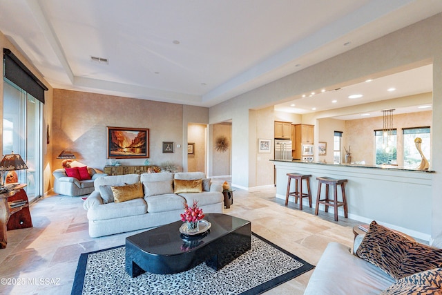 living room featuring a tray ceiling