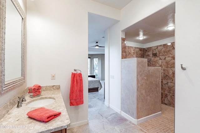 bathroom featuring vanity, ceiling fan, and tiled shower