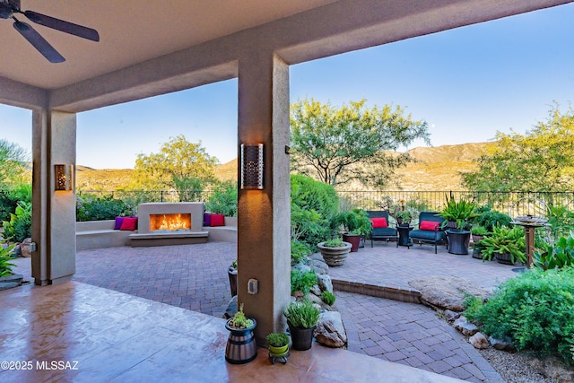 view of patio with a mountain view and ceiling fan