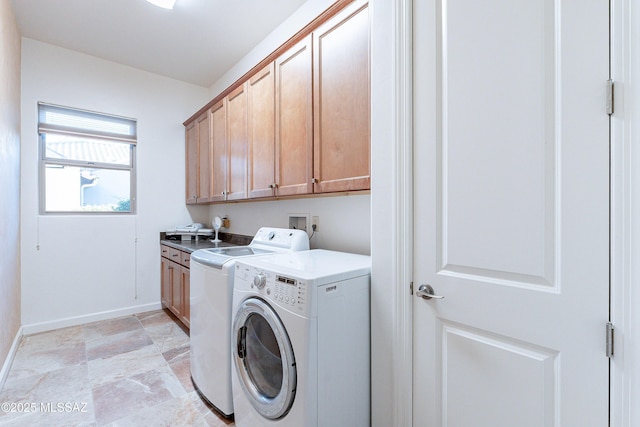 washroom with cabinets and washing machine and dryer