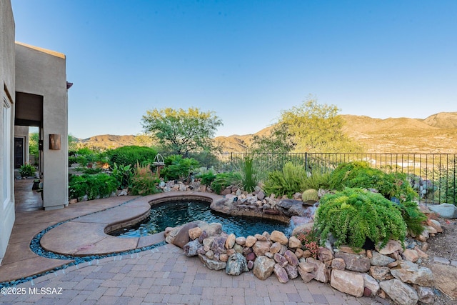 view of swimming pool with a mountain view