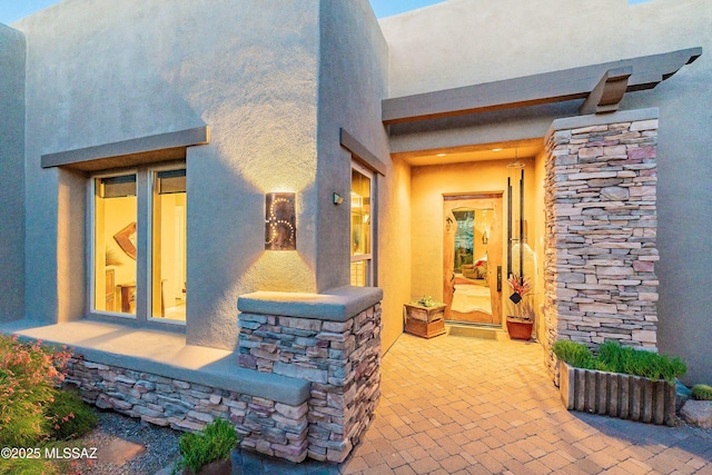 entrance to property with a patio area