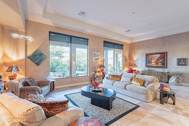 living room featuring a tray ceiling