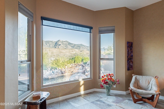 sitting room with a wealth of natural light and a mountain view