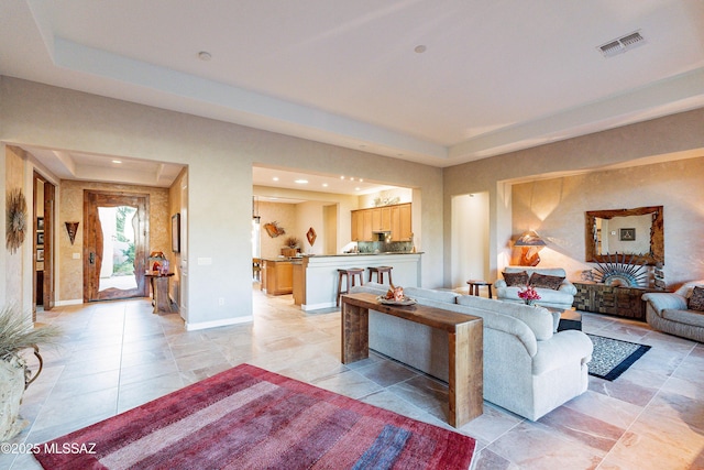 living room with a raised ceiling