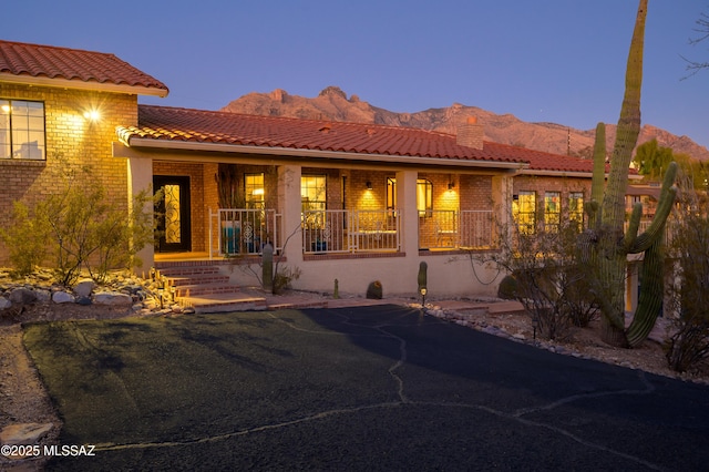 view of front of property featuring a mountain view and covered porch