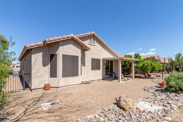 back of property with a patio