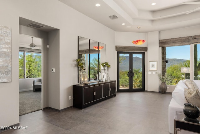 interior space featuring a mountain view, french doors, and a healthy amount of sunlight