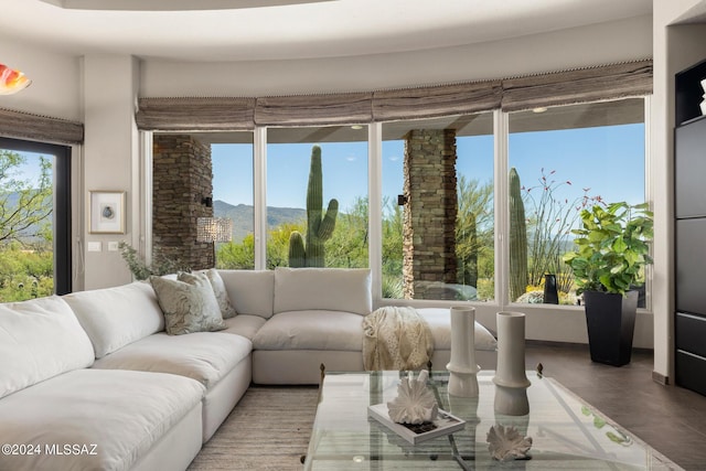 sunroom / solarium featuring a wealth of natural light and a mountain view