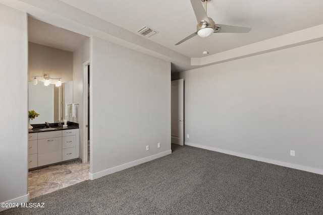 unfurnished bedroom featuring carpet, ceiling fan, and sink