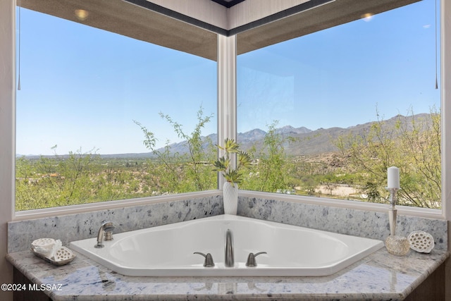 bathroom featuring a mountain view and a bath