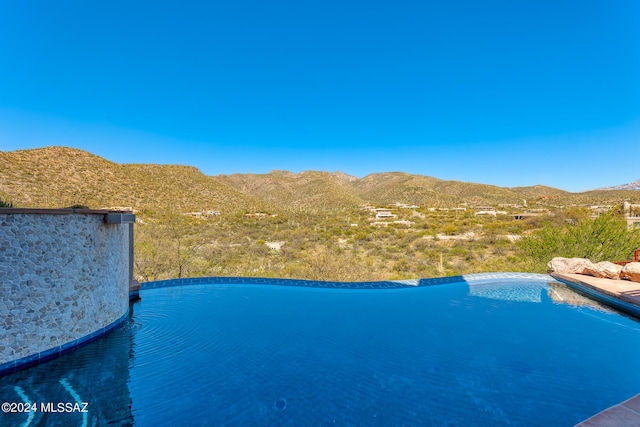 view of swimming pool featuring a mountain view