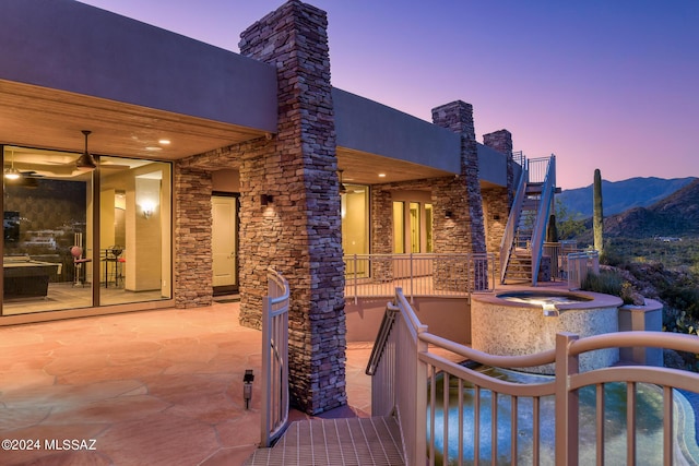 patio terrace at dusk with a mountain view