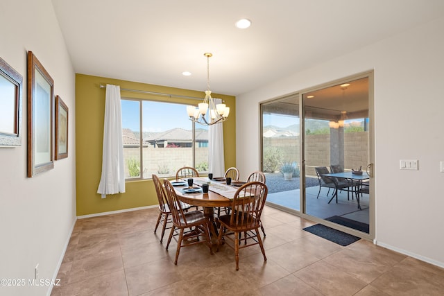 dining space with light tile patterned flooring and a notable chandelier