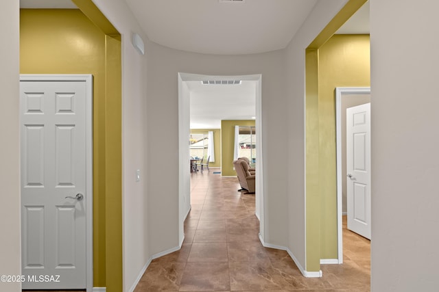 hallway featuring light tile patterned floors