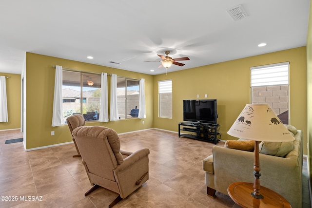 living room featuring ceiling fan and light tile patterned floors