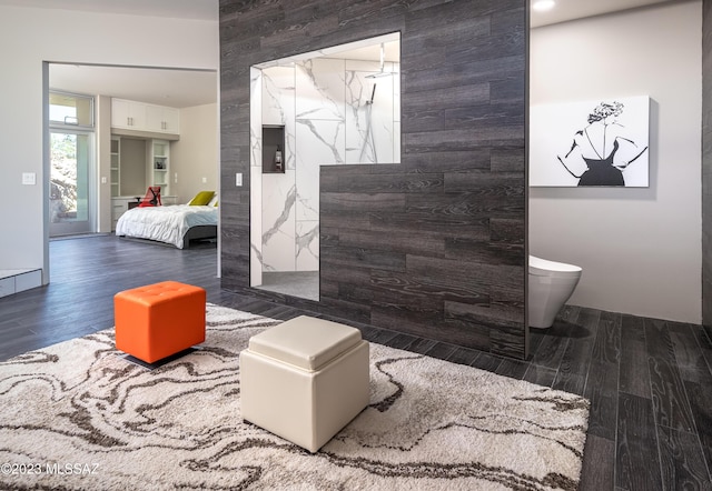 bathroom with hardwood / wood-style floors, toilet, and walk in shower