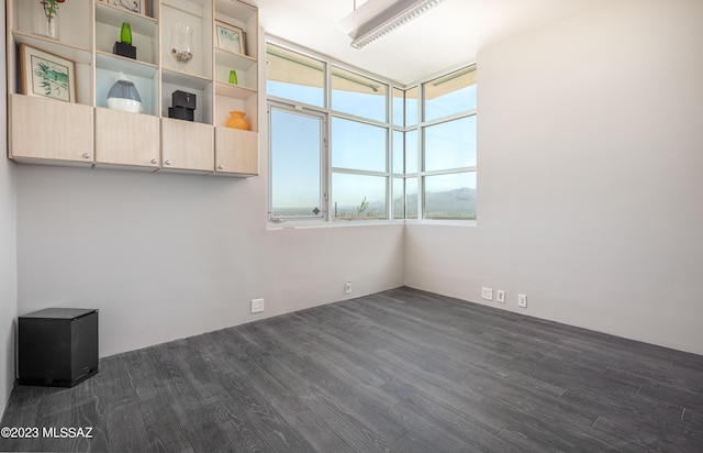 spare room featuring dark hardwood / wood-style flooring