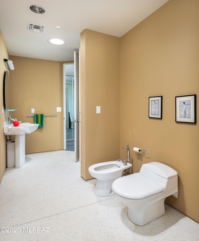 bathroom with a bidet and toilet