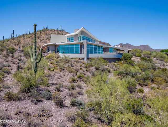 back of property featuring a mountain view