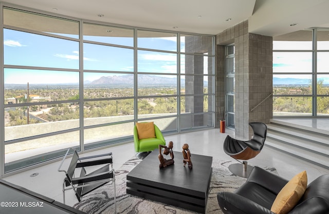 living room with expansive windows and a healthy amount of sunlight