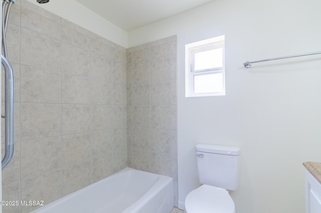 full bathroom with vanity, tiled shower / bath, and toilet