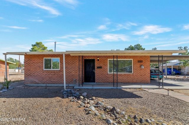 single story home featuring a carport