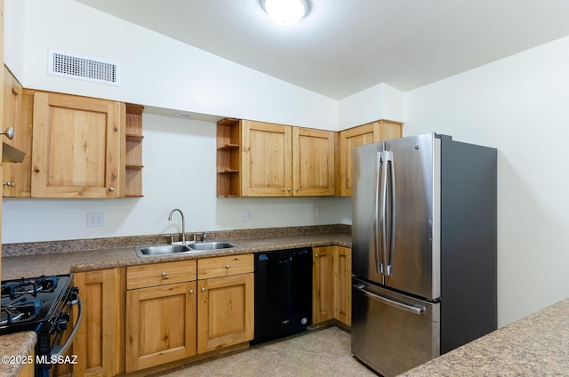 kitchen featuring sink, light tile patterned floors, and black appliances