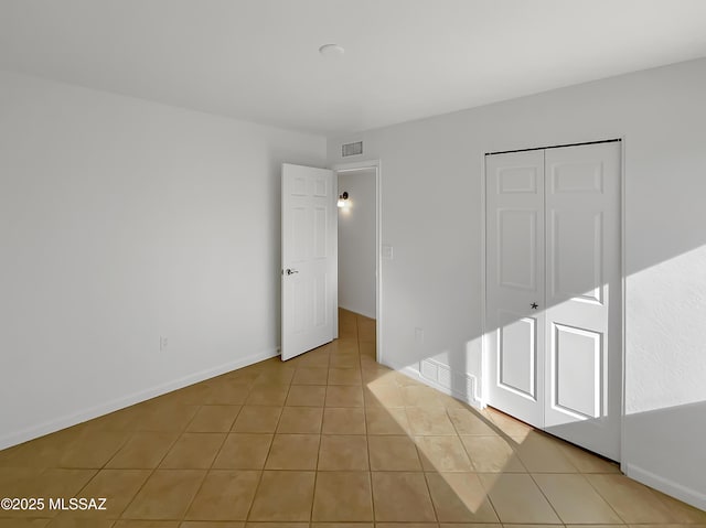 interior space featuring a closet and light tile patterned flooring