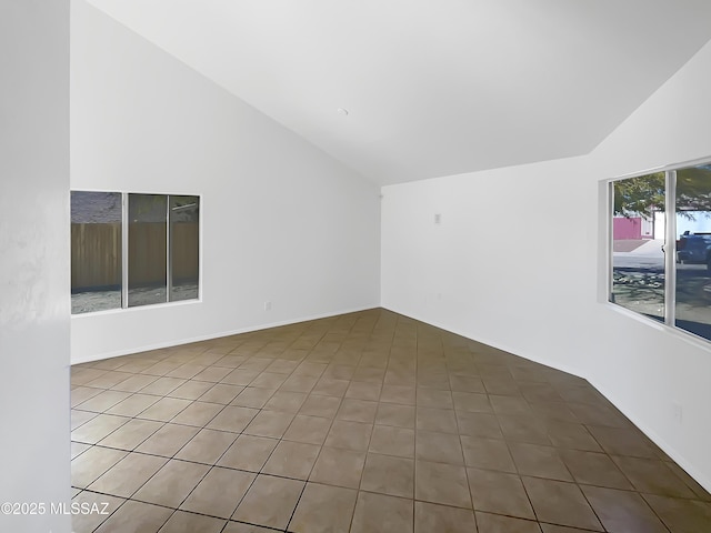 unfurnished room featuring tile patterned floors and lofted ceiling