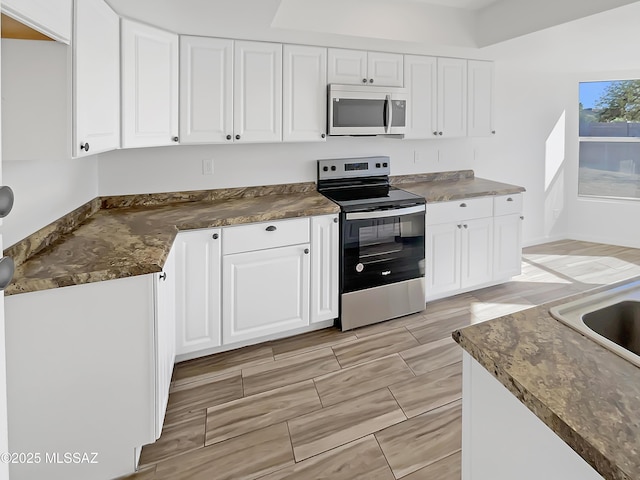 kitchen with white cabinetry and stainless steel electric range oven