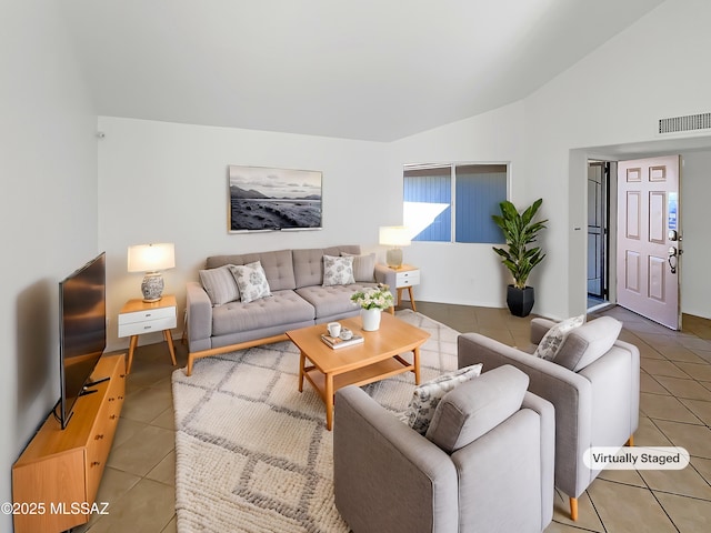 living room with tile patterned flooring and vaulted ceiling