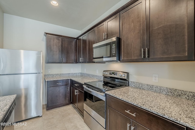 kitchen featuring light tile patterned floors, appliances with stainless steel finishes, dark brown cabinets, recessed lighting, and light stone countertops