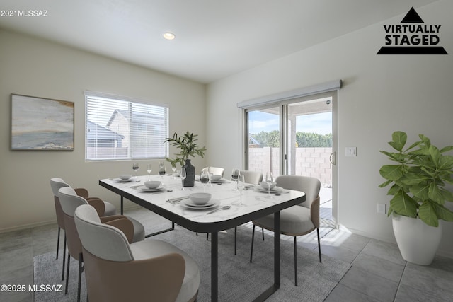 dining space with light tile patterned floors and recessed lighting