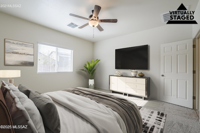 carpeted bedroom featuring visible vents and a ceiling fan