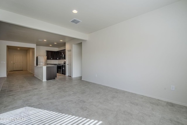 unfurnished living room with visible vents, baseboards, and recessed lighting