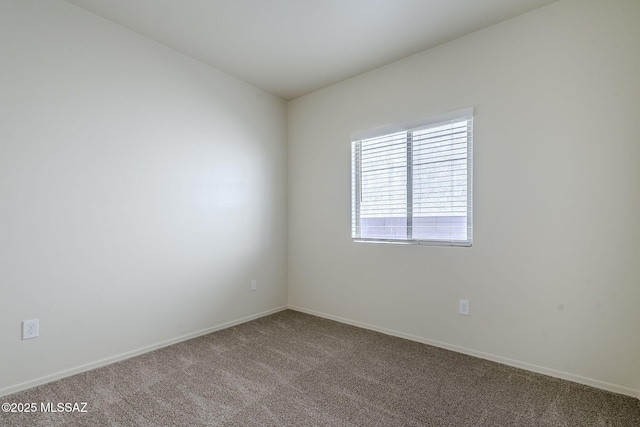empty room with carpet flooring and baseboards