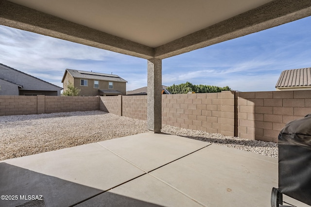 view of patio with a fenced backyard and a grill