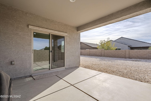view of patio / terrace featuring fence