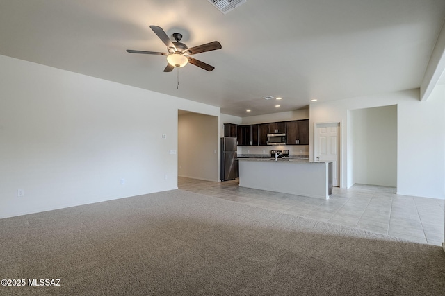 unfurnished living room with recessed lighting, a ceiling fan, light tile patterned flooring, visible vents, and light colored carpet
