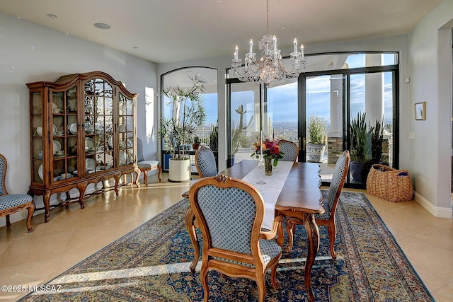 dining area featuring light tile patterned floors and a chandelier